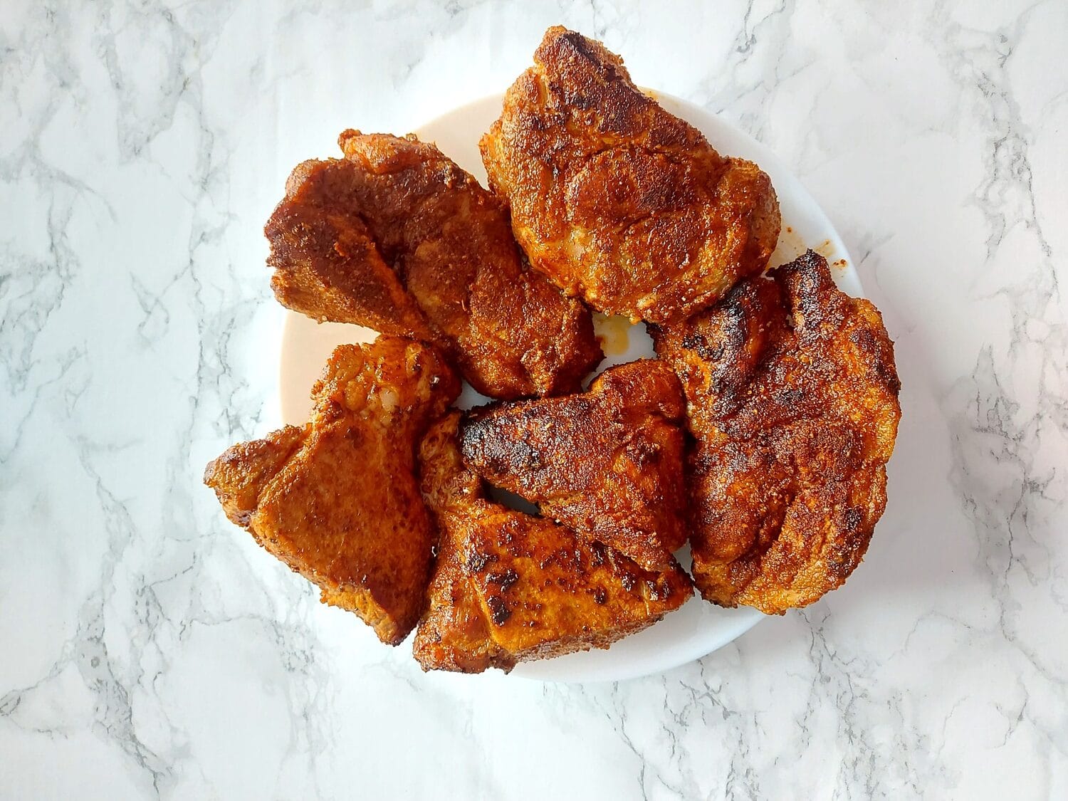 Seared dry rubbed BBQ pork pieces