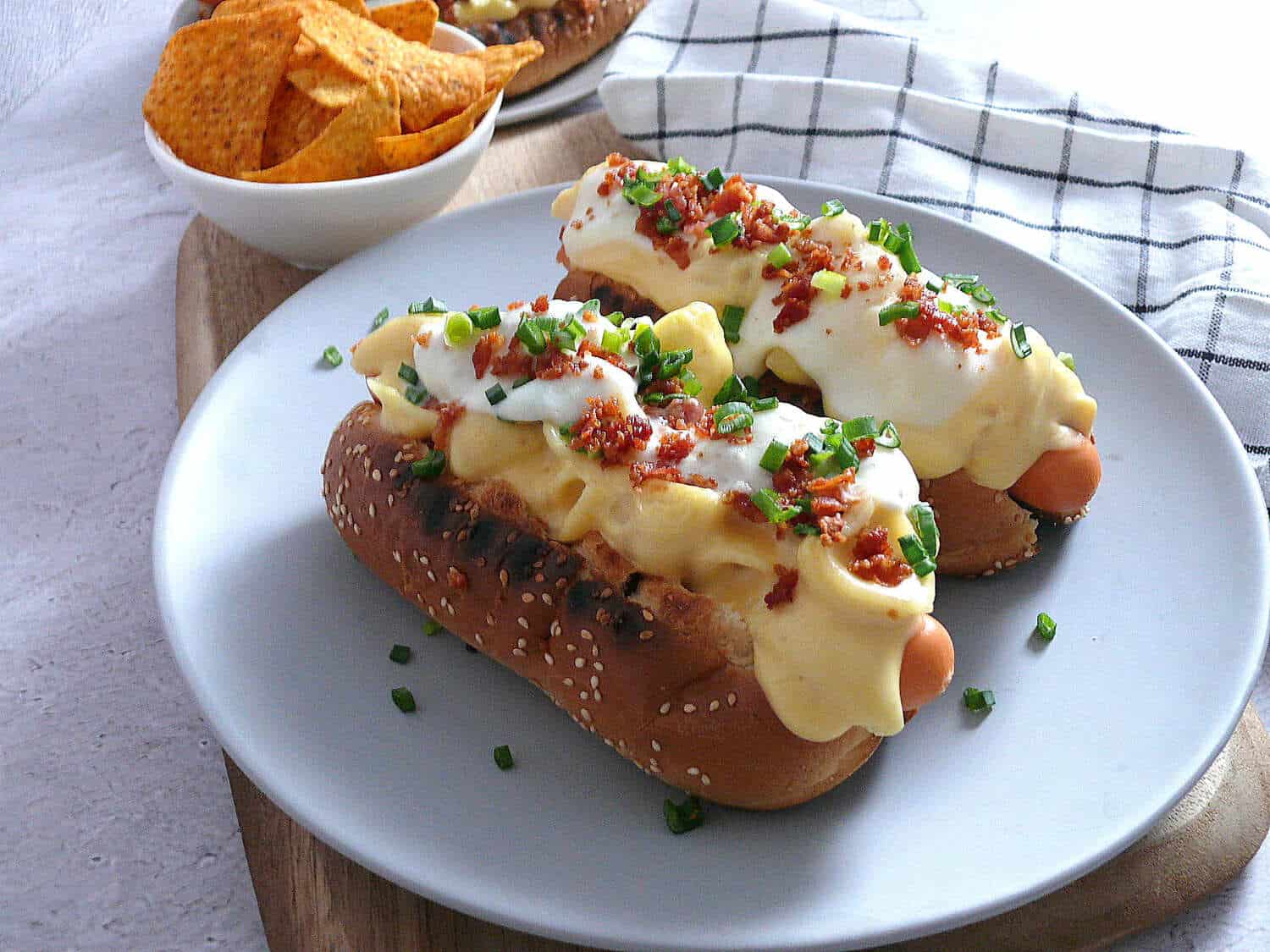 Hot dogs on a plate with chips