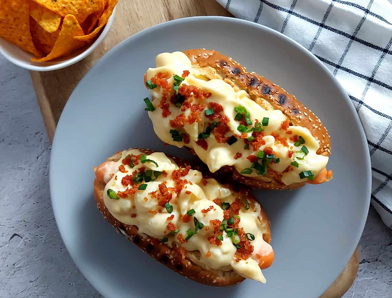 Mac and cheese hot dogs on a grey plate