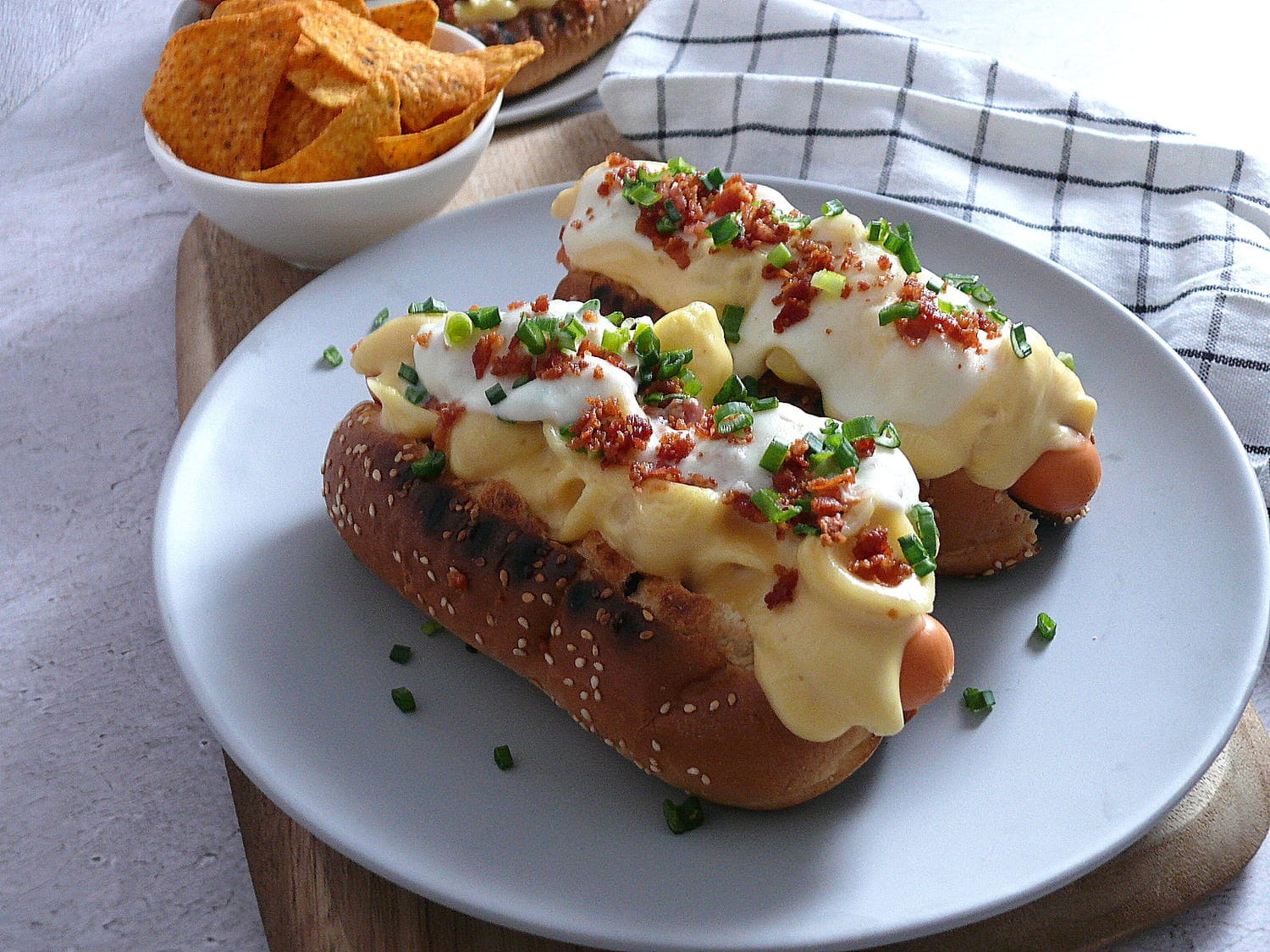 Loaded hot dogs on a grey plate