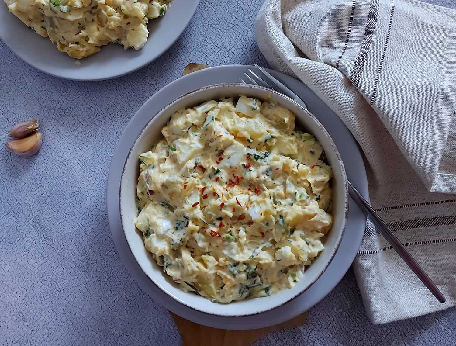 Creamy potato salad in a bowl with fork