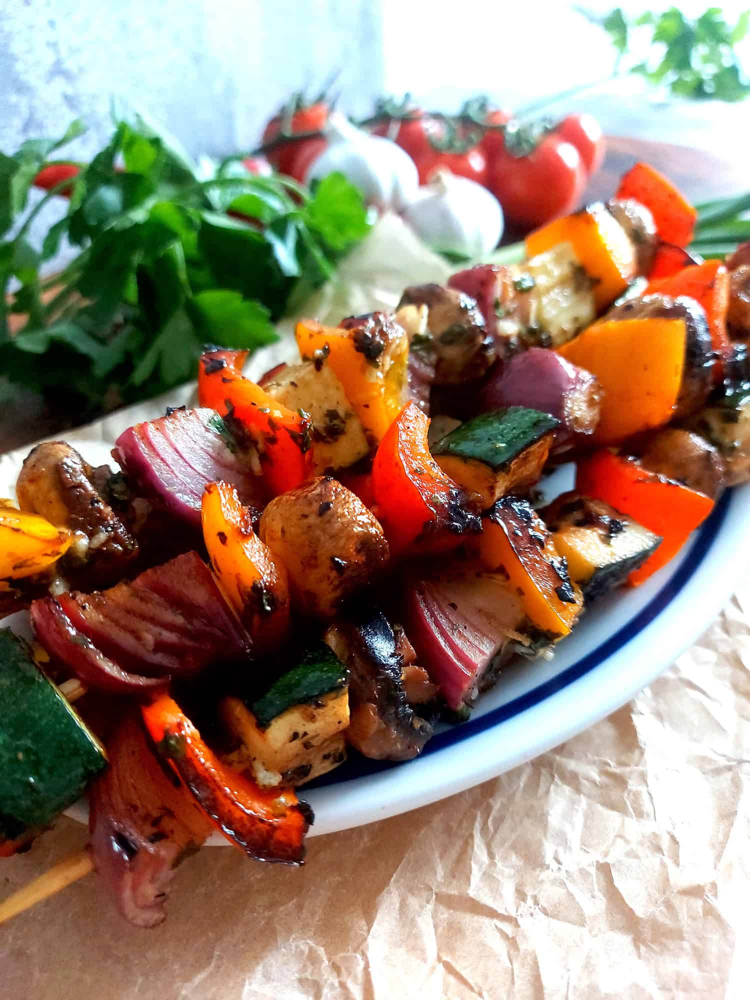 Charred vegetable skewers on a plate