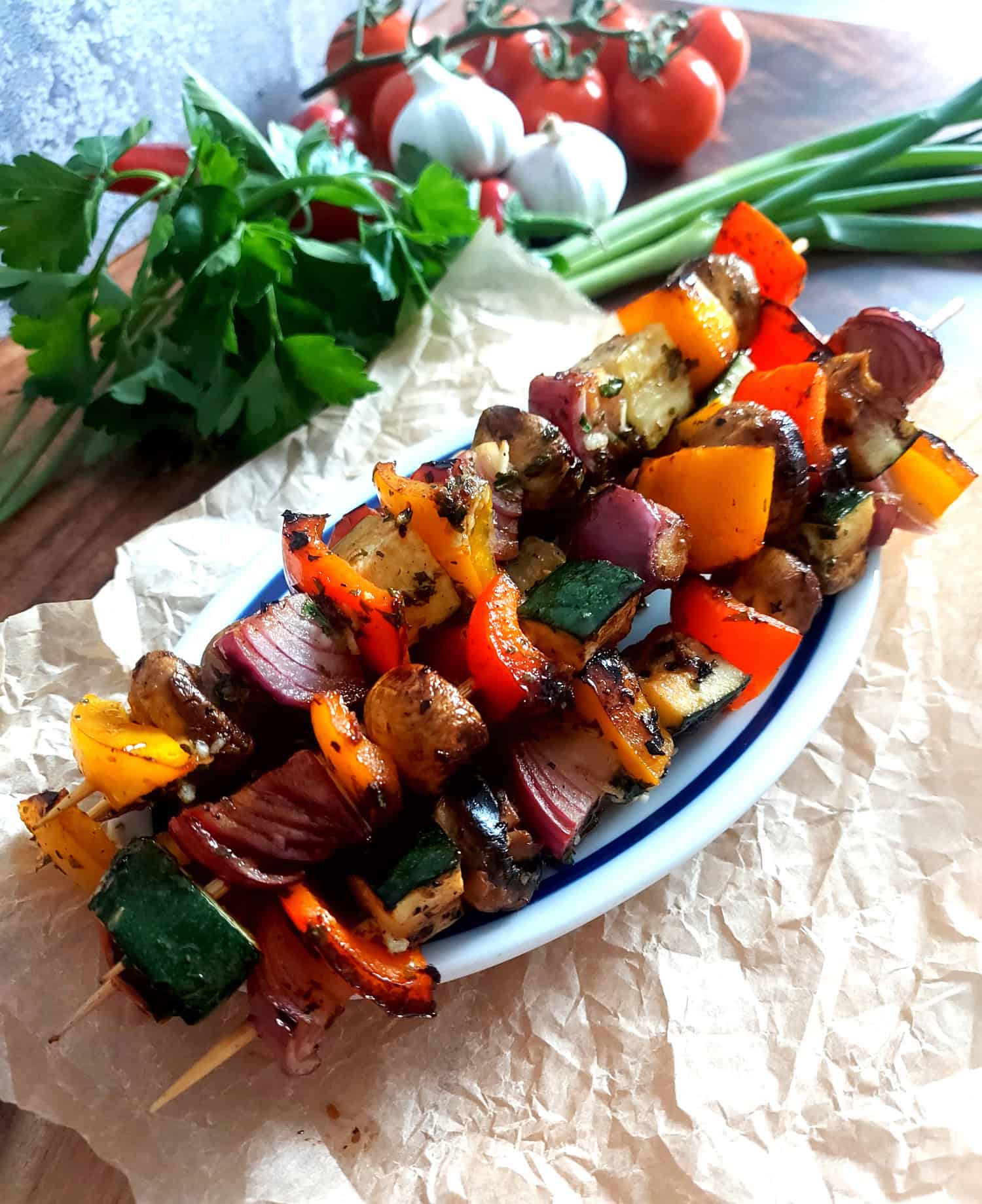 Grilled veggie skewers on baking paper