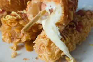 CLOSE UP OF AN OOZY CHEESE DOG