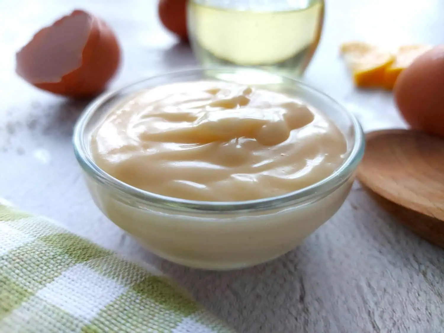 Easy Mayonnaise in a glass ramekin next to a green napkin