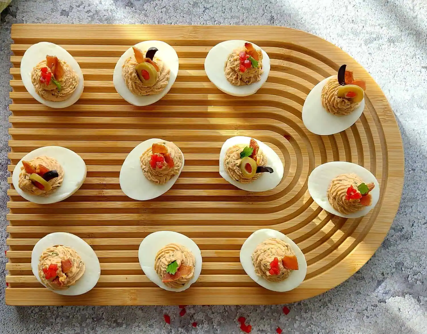 OVERHEAD SHOT OF A BATCH OF GARNISHED DEVILED EGGS
