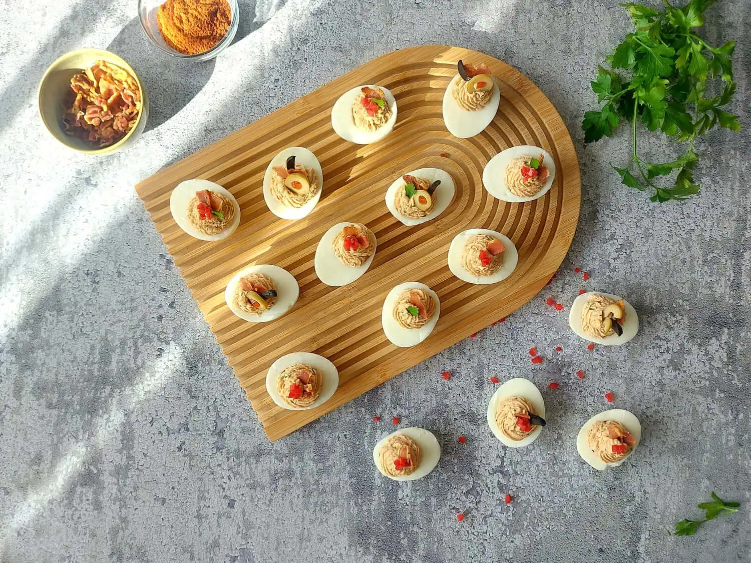 DEVILED EGGS WITH BACON ON A GREY BACKGROUND