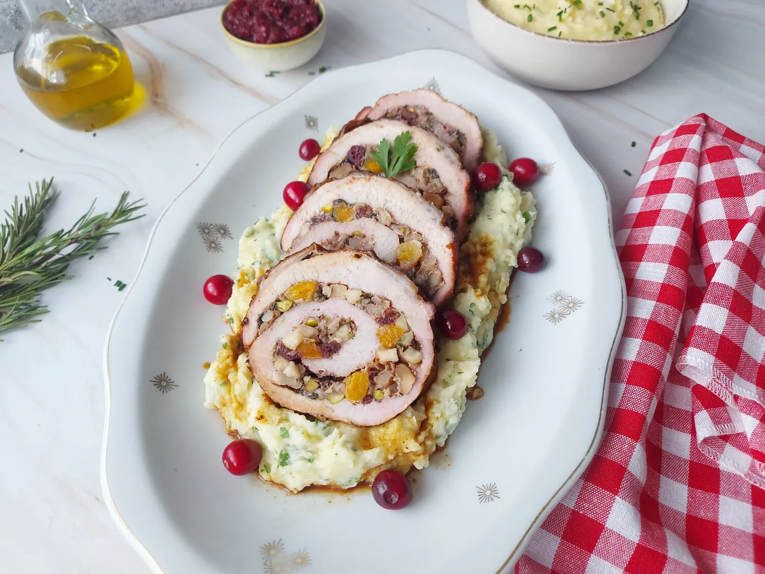 cranberry apple stuffed pork loin Slices of stuffed pork on a bed of mashed potatoes with gravy