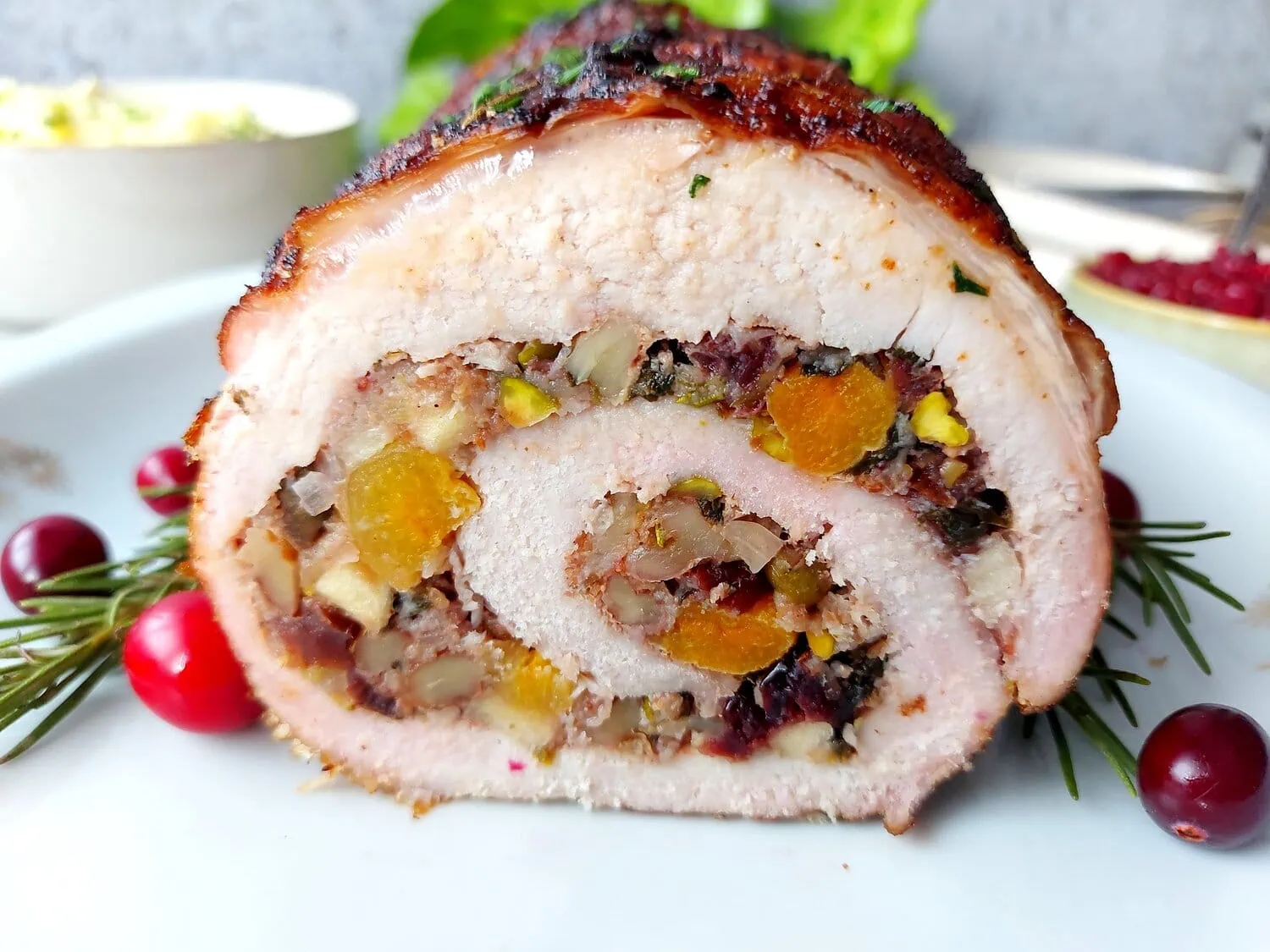 cranberry apple stuffed pork loin Close up shot of a cut apple stuffed pork roast