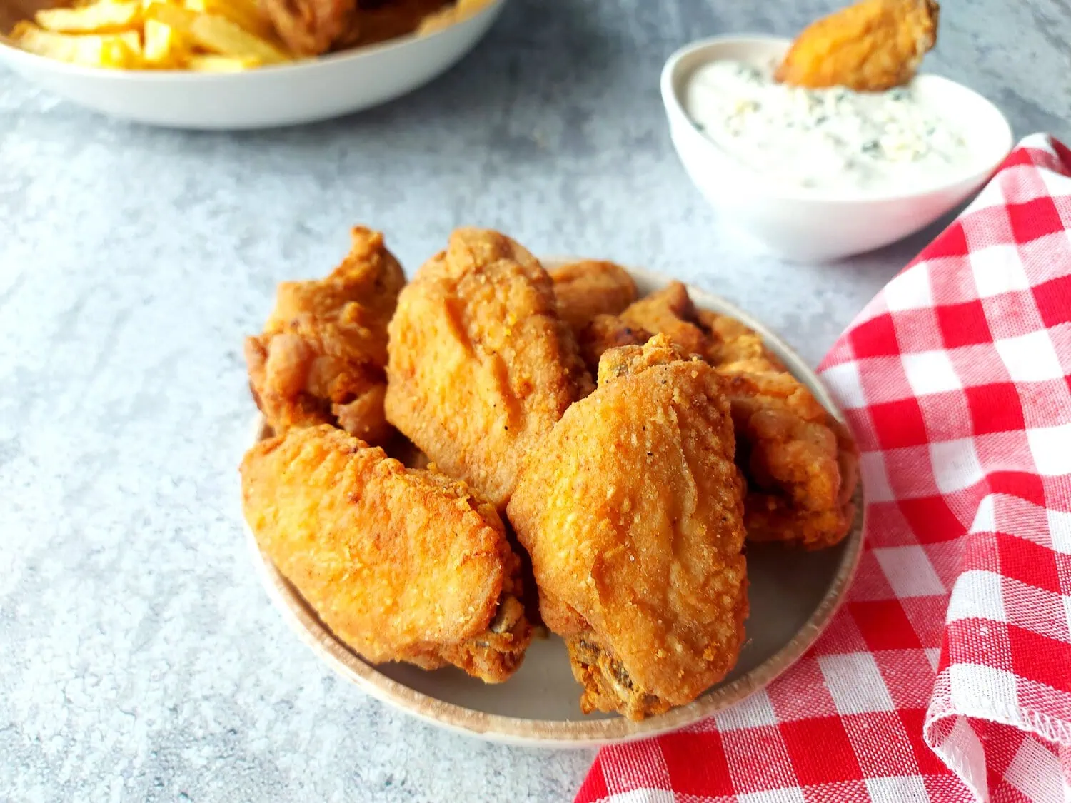 crispy fried chicken wings recipe Crunchy wings on a small plate, with blue cheese dip and a red and white napkin