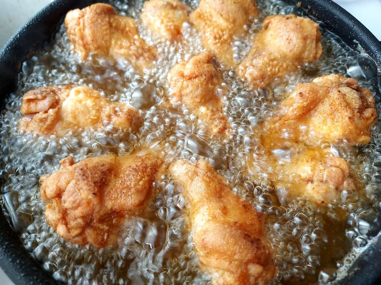 crispy fried chicken wings recipe golden chicken wings frying in a pot of oil