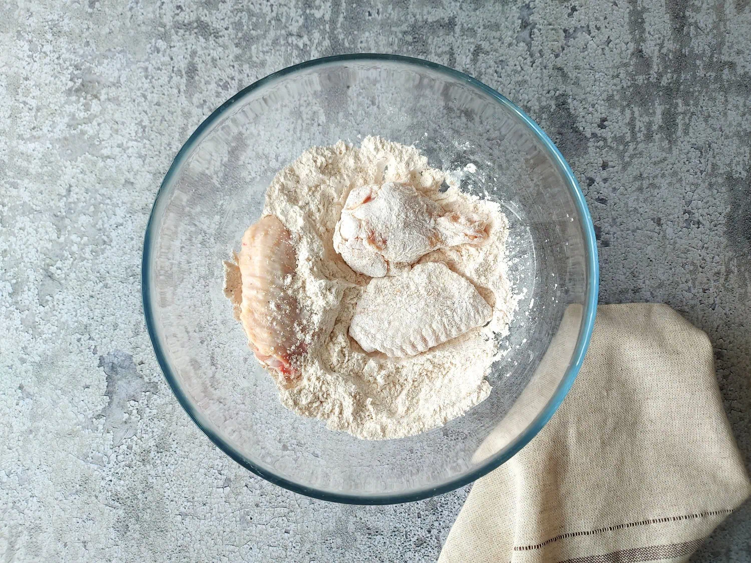 crispy fried chicken wings recipe Chicken wings in a bowl with the flour mixture, made of corn starch, baking powder, garlic powder, onion powder, smoked paprika, seasoning salt and black pepper.