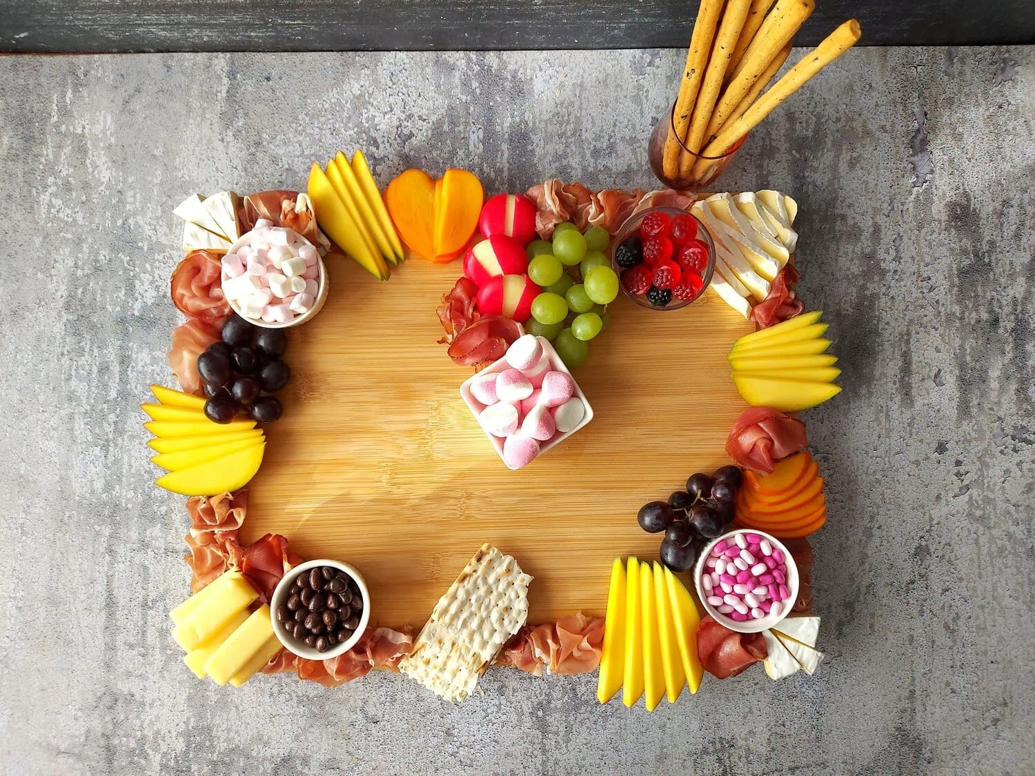 valentine's day charcuterie easy valentine charcuterie board with cheeses, variety of meats, crackers, candies, sweet treats and grapes