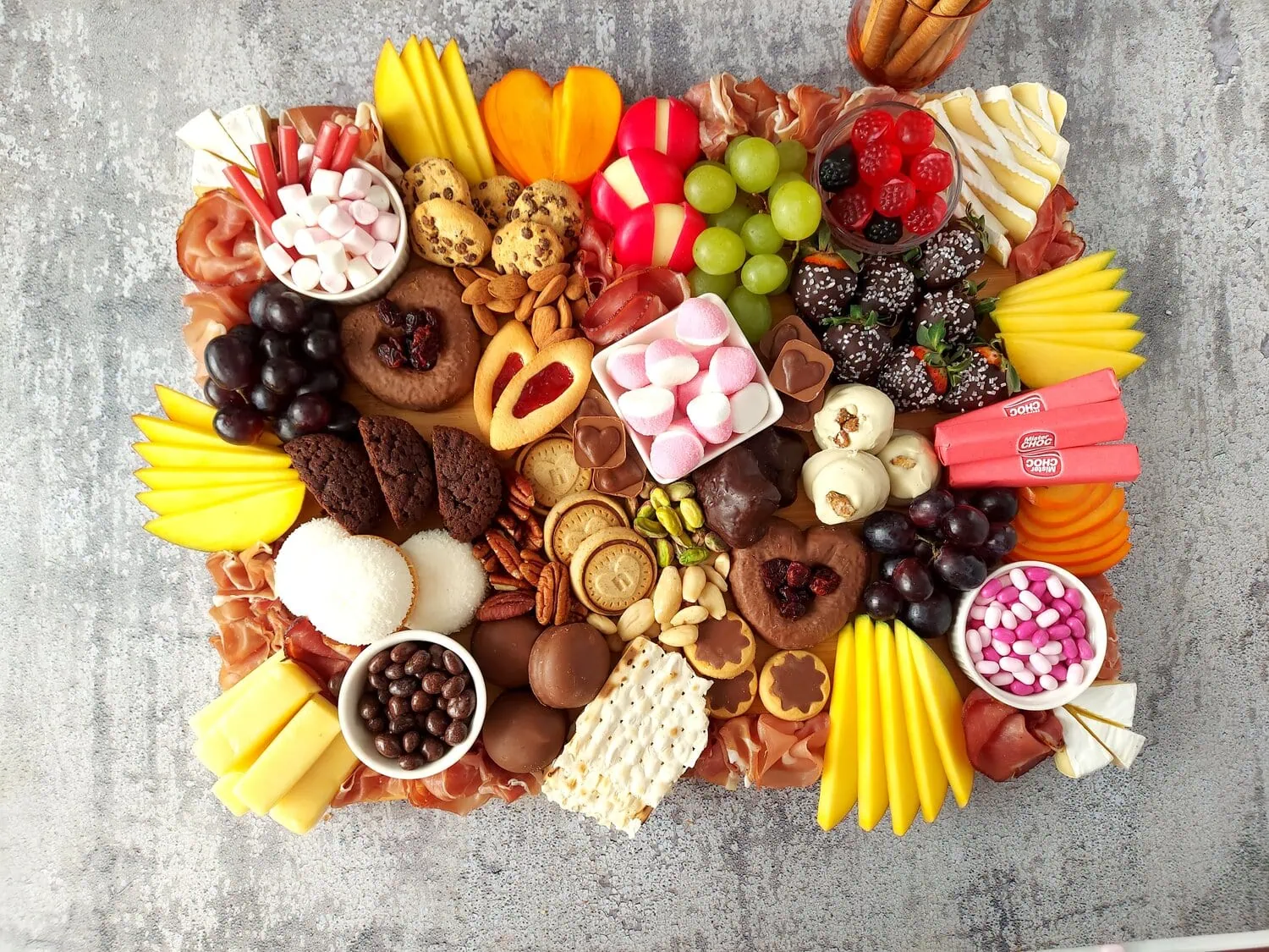 valentine's day charcuterie romantic charcuterie board with fruits, sweets, a variety of meats, dried fruit and nuts