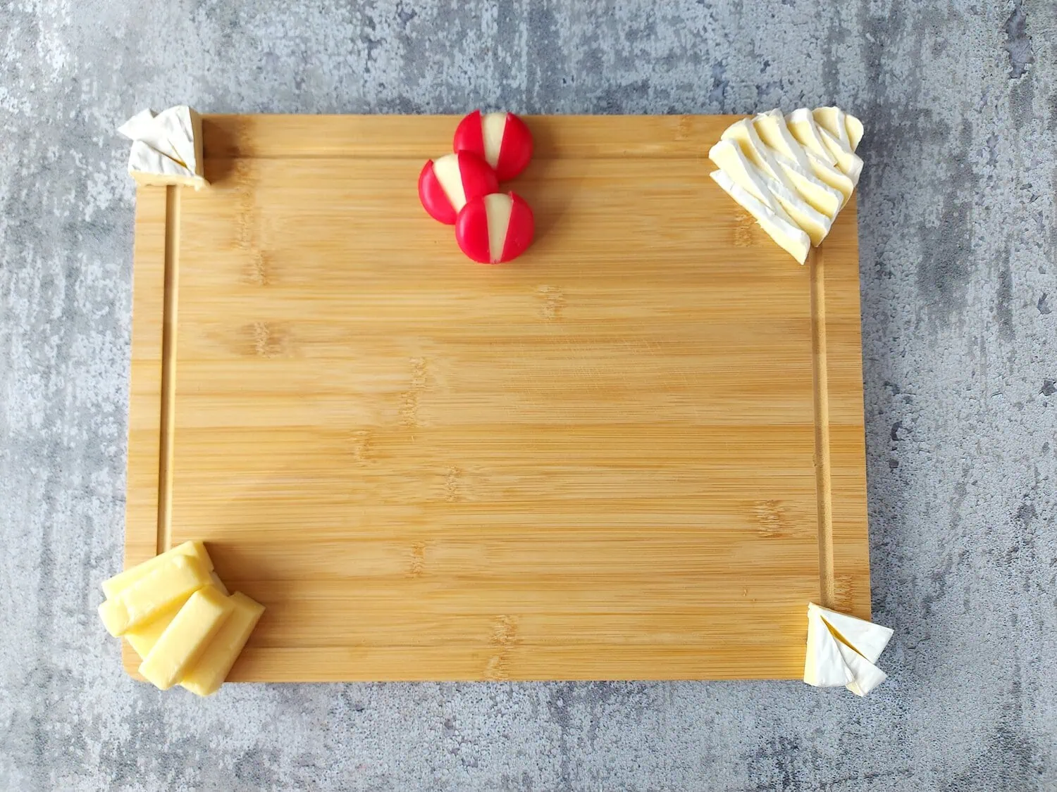 valentine's day charcuterie large wooden board with different varieties of cheese for a romantic charcuterie board for two
