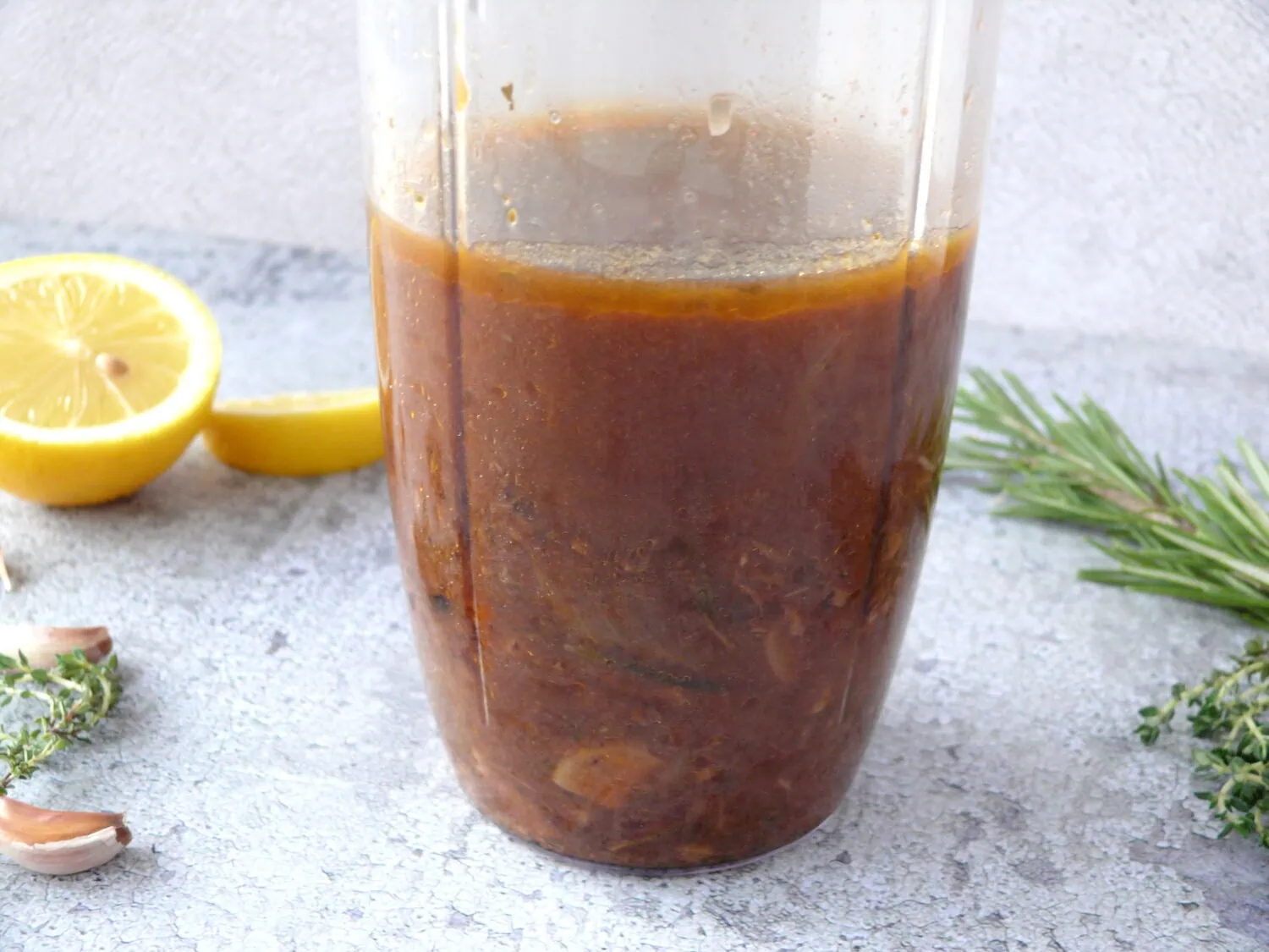 Pan juices, with garlic and onions in a transparent blender cup