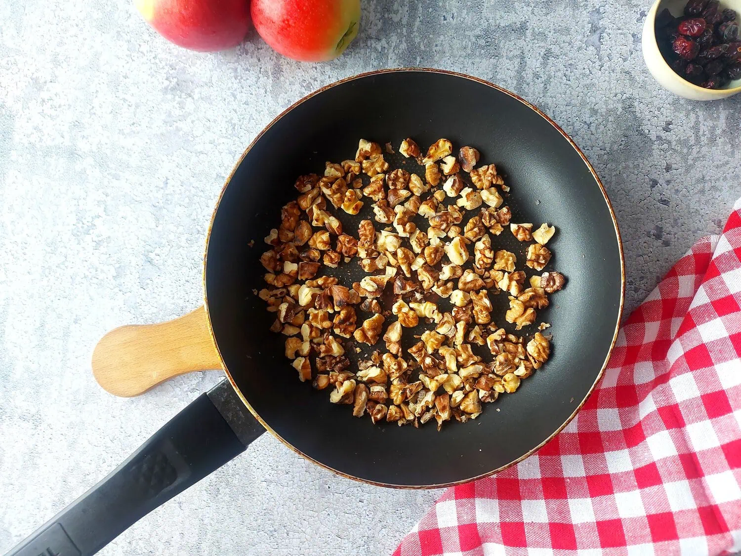 Toasted walnuts in a frying pan