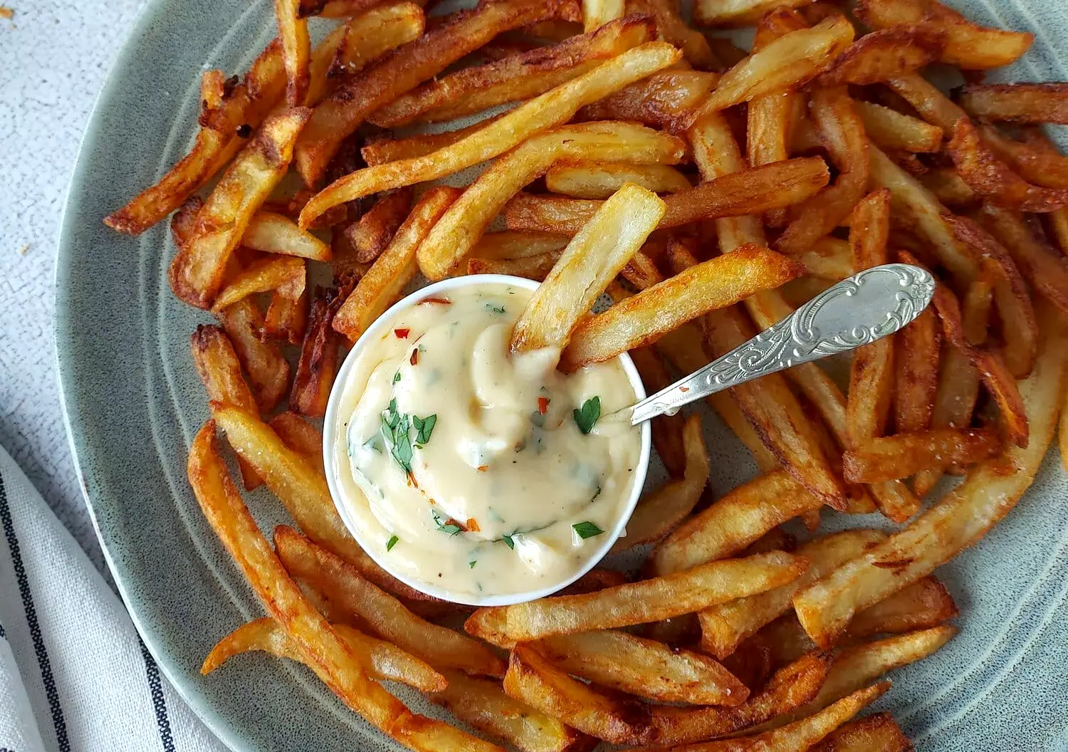 Garlic mayo aioli with French fries on a plate