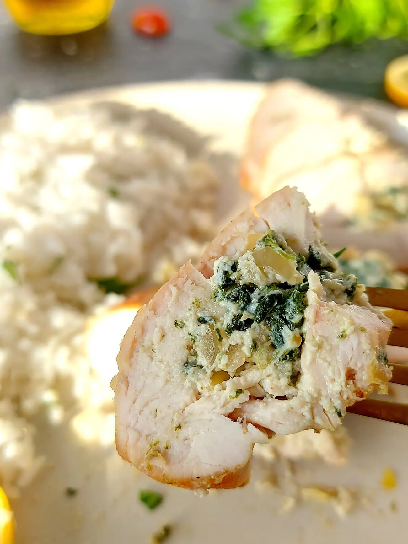 close up shot of a slice of ricotta chicken on a fork