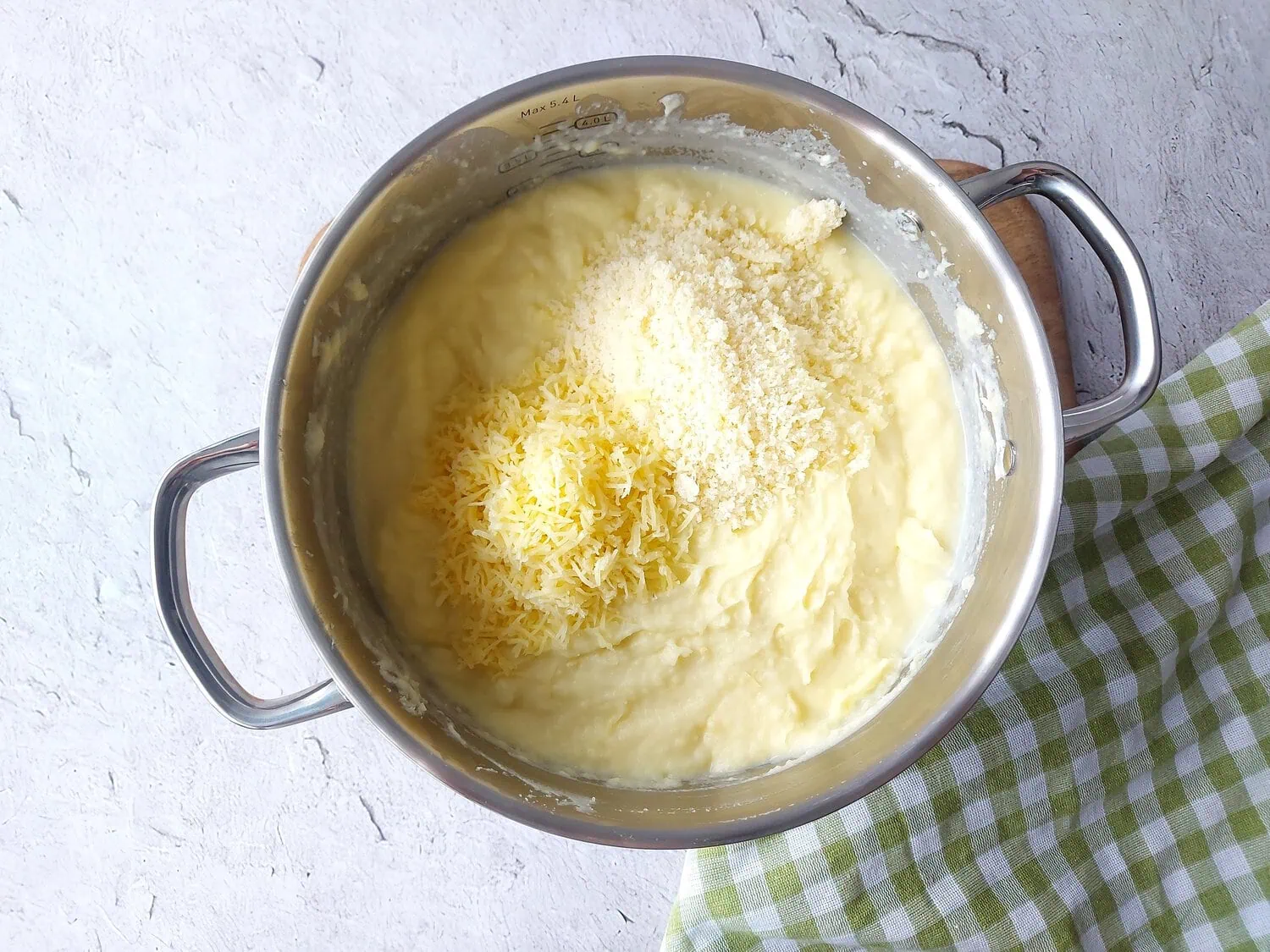 Creamy mashed potatoes topped with Gruyere cheese and Parmesan cheese