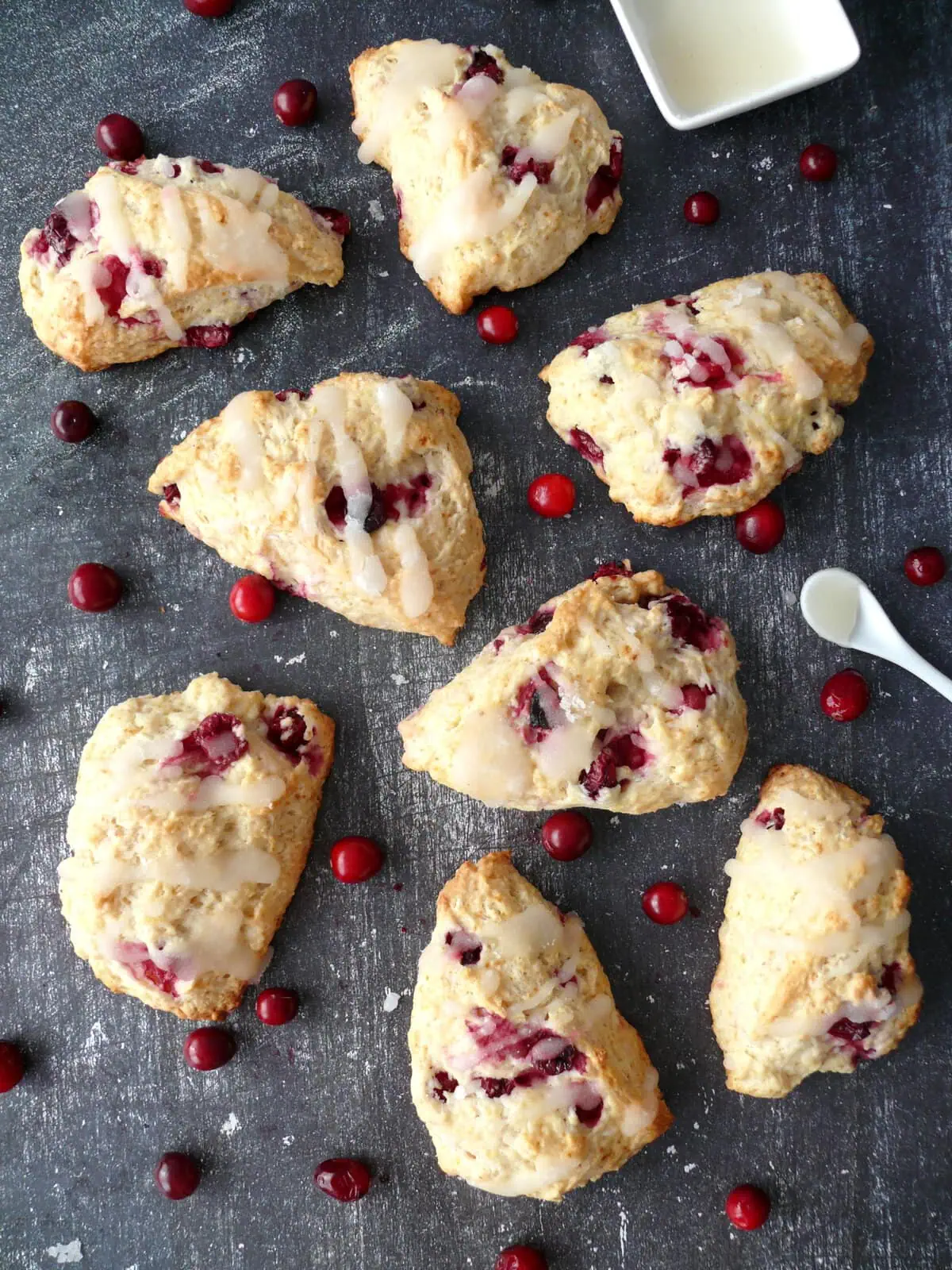 eggless scone recipe Lemon glazed eggless scones made with this eggless scone recipe, with fresh cranberries and lemon glazed on a table