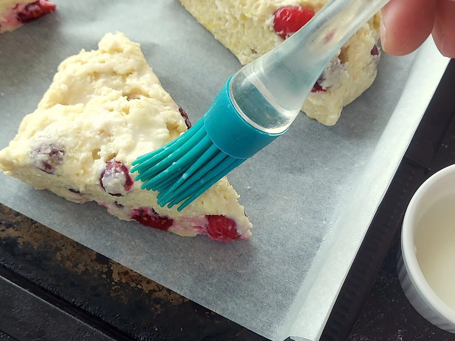 eggless scone recipe Brushing milk on an eggless scone