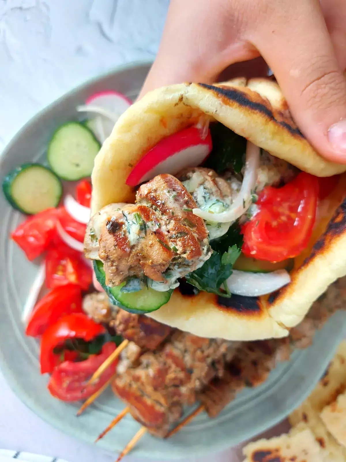 traditional greek souvlaki chicken souvlaki wrap with tomatoes, onions, cucumbers, and tzatziki sauce