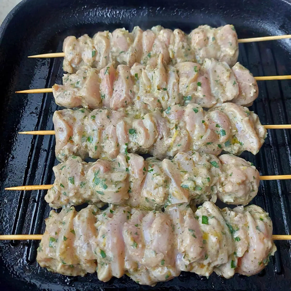 traditional greek souvlaki greek souvlaki skewers on a stovetop grill pan