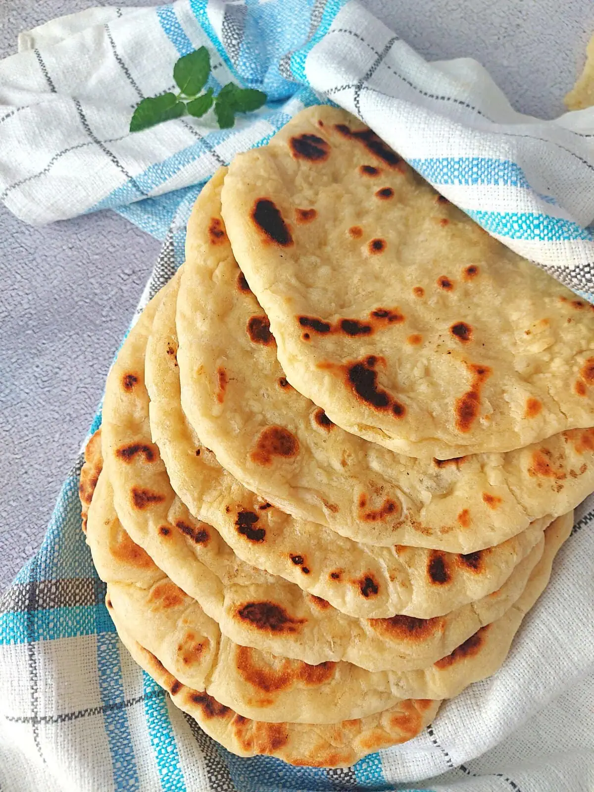 Freshly cooked Greek pita bread with golden brown spots