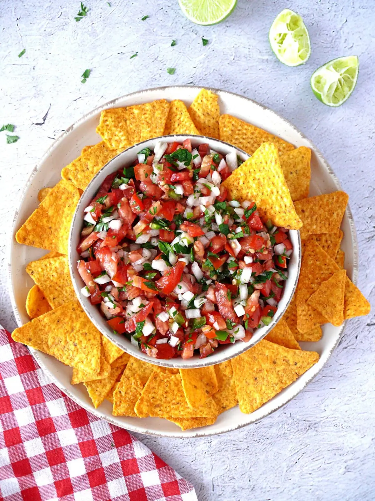 fresh pico de gallo recipe Overhead of fresh Pico de Gallo Recipe made with vine tomatoes, onion, parsley, green bell pepper, and lime juice and served with tortilla chips