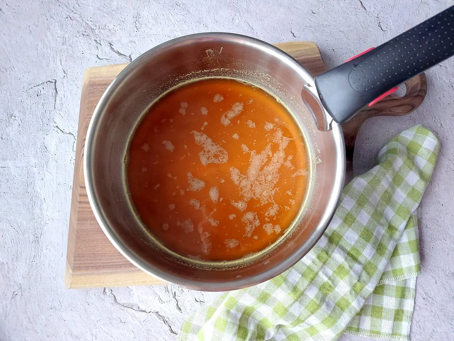 homemade cranberry sauce with orange juice Orange juice mixed with water and brown sugar in a saucepan
