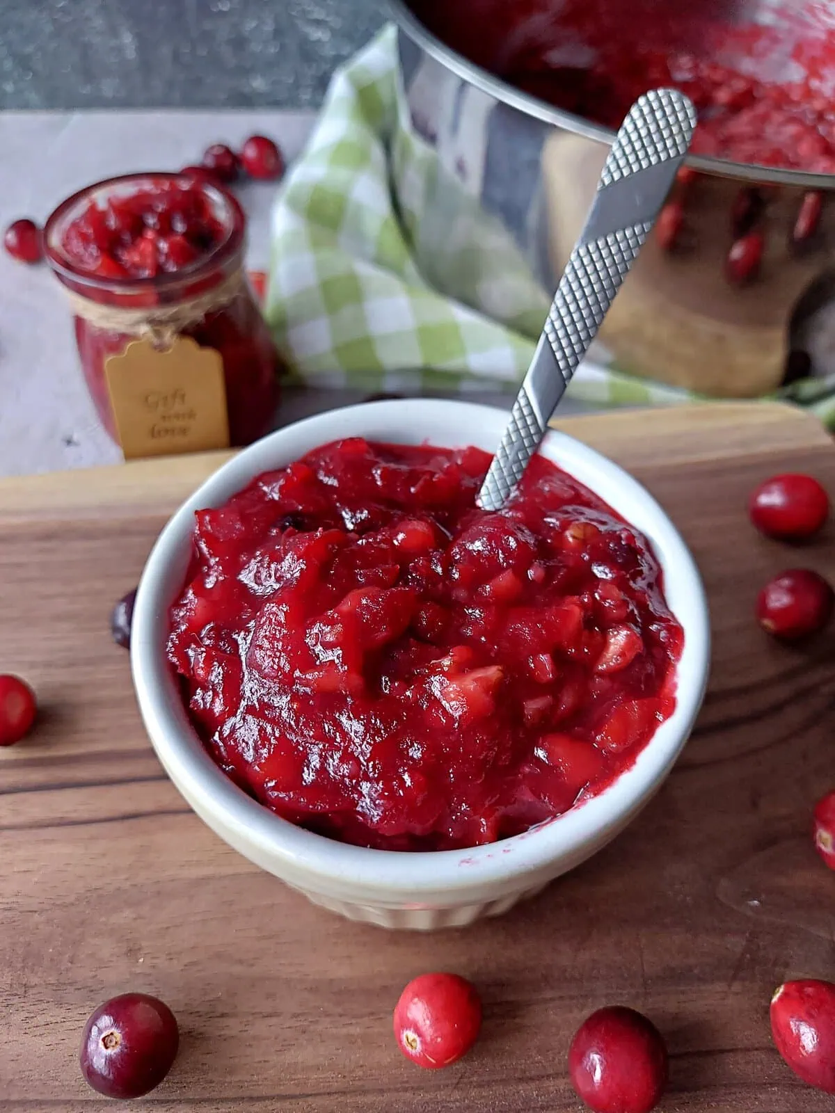 homemade cranberry sauce with orange juice Homemade cranberry sauce with orange juice in a small ramekin with a spoon